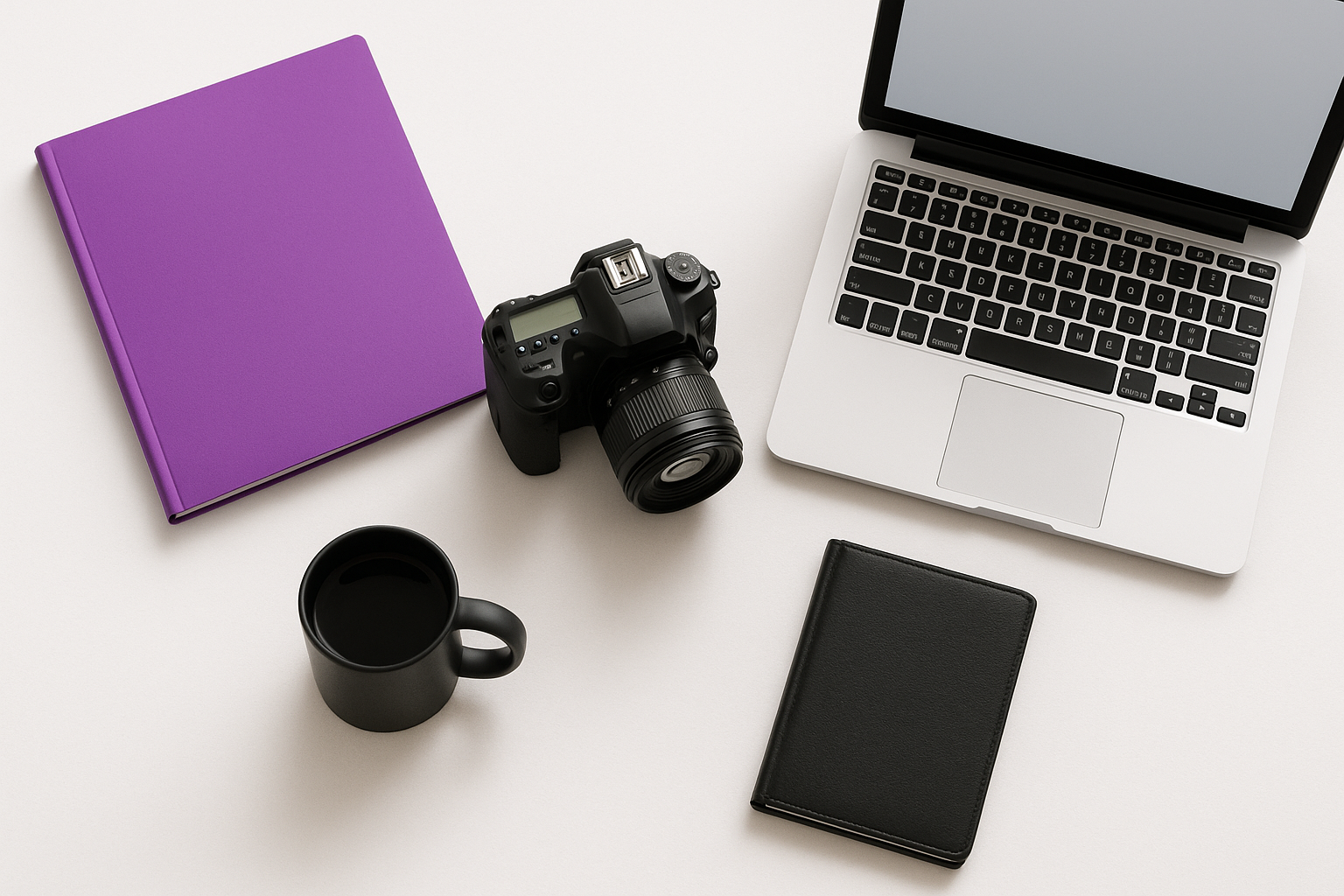 brand photographer flatlay - camera, purple binder, laptop, black mug, black notebook 